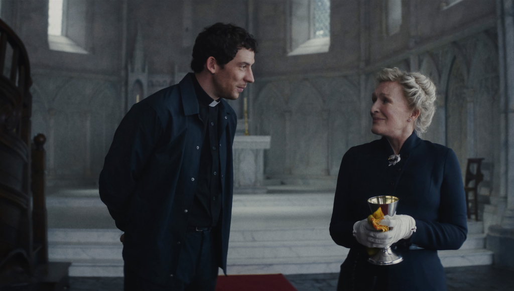 Josh O'Connor as Father Jud and Glenn Close as Martha Delacroix in WAKE UP THE DEAD